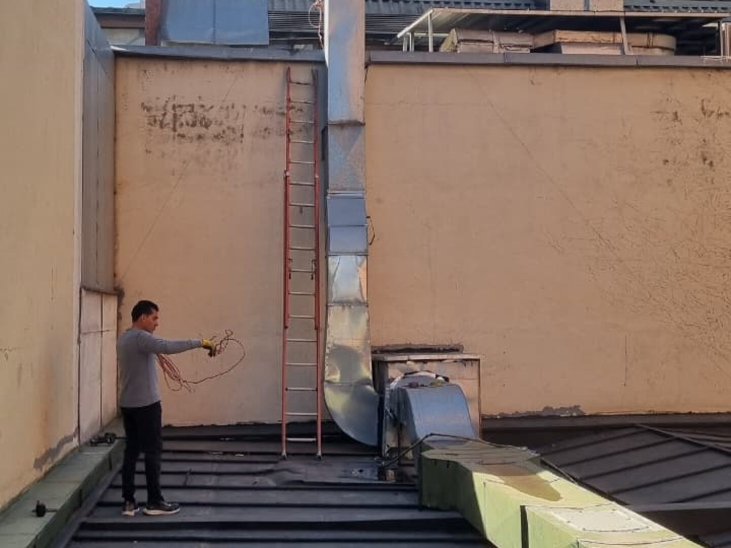 Técnico realizando conexiones eléctricas en el ducto de extracción